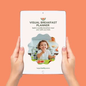 Hands holding an ipad showing the cover for Happy Healthy Eater's breakfast planner